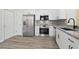 Modern kitchen with white cabinets and granite counters at 18924 Duquesne Dr, Tampa, FL 33647