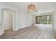 Open living area with laminate floors and access to patio at 18924 Duquesne Dr, Tampa, FL 33647