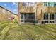 Screened patio with AC unit and grassy backyard at 18924 Duquesne Dr, Tampa, FL 33647