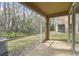 Peaceful screened porch with view of wooded area at 18924 Duquesne Dr, Tampa, FL 33647