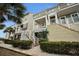 Townhome exterior with stairs and lush landscaping at 19915 Gulf Blvd # 605, Indian Shores, FL 33785