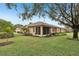 View of house exterior and landscaped backyard at 2028 Acadia Greens Dr, Sun City Center, FL 33573