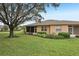 Landscaped backyard with screened patio at 2028 Acadia Greens Dr, Sun City Center, FL 33573