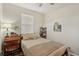 Well-lit bedroom with a full-size bed and a functional workspace at 2028 Acadia Greens Dr, Sun City Center, FL 33573