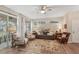 Bright living room with hardwood floors, comfy seating, and lots of natural light at 2028 Acadia Greens Dr, Sun City Center, FL 33573