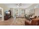Open living space with hardwood floors, comfortable seating, and a large TV at 2028 Acadia Greens Dr, Sun City Center, FL 33573