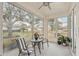 Bright sunroom with ample seating and treetop views at 2028 Acadia Greens Dr, Sun City Center, FL 33573