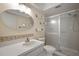 Clean bathroom with a large shower, oval mirror and built-in shelves at 2320 Shelly Dr # B, Palm Harbor, FL 34684