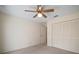 Well-lit bedroom with ceiling fan and bi-fold closet doors at 2320 Shelly Dr # B, Palm Harbor, FL 34684