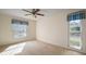 Well-lit bedroom with carpet and two windows at 2320 Shelly Dr # B, Palm Harbor, FL 34684