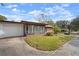 White garage door and side view of a brick ranch home at 2320 Shelly Dr # B, Palm Harbor, FL 34684