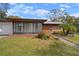 Brick ranch home with a sunroom and well-manicured lawn at 2320 Shelly Dr # B, Palm Harbor, FL 34684