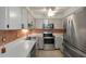 Galley kitchen with stainless steel appliances at 2320 Shelly Dr # B, Palm Harbor, FL 34684
