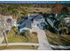 Aerial view of beautiful home with gazebo, backyard bordered by trees, and two-car garage at 2930 Swan Cir, Dunedin, FL 34698