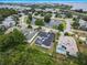 An aerial view of the home, located on a pond, in a neighborhood setting at 2930 Swan Cir, Dunedin, FL 34698