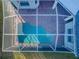 Aerial view of screened pool area and fenced-in backyard at 2930 Swan Cir, Dunedin, FL 34698
