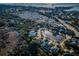 An aerial view of the community which features a pond and mature trees at 2930 Swan Cir, Dunedin, FL 34698