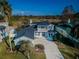 Aerial view of beautiful home with gazebo, backyard bordered by trees, and two-car garage at 2930 Swan Cir, Dunedin, FL 34698