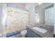 Well-lit bathroom featuring a shower/tub combo and granite-topped vanity at 2930 Swan Cir, Dunedin, FL 34698