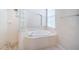 Bright bathroom showcasing a soaking tub and separate glass-block shower at 2930 Swan Cir, Dunedin, FL 34698