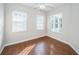 Bedroom with hardwood floors, ceiling fan and large windows at 2930 Swan Cir, Dunedin, FL 34698