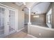 Neutral walls and arched entryway in this well-lit bedroom with carpet floors at 2930 Swan Cir, Dunedin, FL 34698