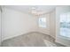 Comfortable carpeted bedroom featuring a ceiling fan and bright, sunlit windows at 2930 Swan Cir, Dunedin, FL 34698