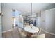 Inviting dining area with modern decor, table set, and views of the spacious kitchen at 2930 Swan Cir, Dunedin, FL 34698