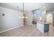 Bright and airy dining area with an elegant chandelier and neutral color scheme at 2930 Swan Cir, Dunedin, FL 34698