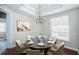 Formal dining room with a modern chandelier, stylish decor, and natural light from the window at 2930 Swan Cir, Dunedin, FL 34698