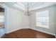 Well-lit dining room features hardwood floors, a hanging light fixture, and a window at 2930 Swan Cir, Dunedin, FL 34698