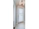 Interior view of a white door with a window and blinds, with tile flooring at 2930 Swan Cir, Dunedin, FL 34698