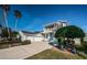 Charming two-story home with a lovely front porch and balcony, three-car garage and landscaped yard at 2930 Swan Cir, Dunedin, FL 34698