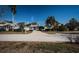Charming two-story home with front balcony, manicured lawn and long drive way at 2930 Swan Cir, Dunedin, FL 34698