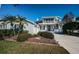 Charming two-story home features a lovely front porch and balcony, landscaped yard and long driveway at 2930 Swan Cir, Dunedin, FL 34698