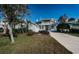 Charming two-story home features a lovely front porch and balcony, landscaped yard and long driveway at 2930 Swan Cir, Dunedin, FL 34698