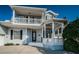 Exterior of a two story home with a white porch and balcony area and light blue siding at 2930 Swan Cir, Dunedin, FL 34698
