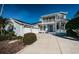 Charming two-story home with light blue siding, a three-car garage, and well-manicured landscaping at 2930 Swan Cir, Dunedin, FL 34698