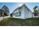 Exterior view of home with a well-maintained lawn, privacy fence and screened-in porch at 2930 Swan Cir, Dunedin, FL 34698