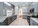 Contemporary kitchen features stainless steel appliances, elegant gray cabinets, and a spacious design at 2930 Swan Cir, Dunedin, FL 34698