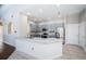Bright, open kitchen with stainless appliances, gray cabinets, granite countertops, and a center island at 2930 Swan Cir, Dunedin, FL 34698