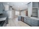 Spacious kitchen showcasing stainless steel appliances, stylish gray cabinets, and an expansive layout at 2930 Swan Cir, Dunedin, FL 34698
