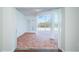 Enclosed brick paved lanai featuring white columns, a ceiling fan, and backyard pool views at 2930 Swan Cir, Dunedin, FL 34698