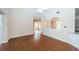 Inviting living room with wood floors, arched entryways, and views into the dining and kitchen areas at 2930 Swan Cir, Dunedin, FL 34698