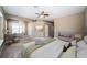 Staged main bedroom features neutral walls, plush carpet, and ceiling fan at 2930 Swan Cir, Dunedin, FL 34698