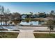Peaceful view of the pond in the community, mature trees and blue sky at 2930 Swan Cir, Dunedin, FL 34698
