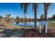 Beautiful pond view features well manicured lawns, mature trees and community signage at 2930 Swan Cir, Dunedin, FL 34698