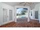 View of screened-in pool and brick patio area through an open archway from inside the home at 2930 Swan Cir, Dunedin, FL 34698