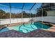 Inviting screened-in pool and brick patio area, perfect for outdoor entertaining at 2930 Swan Cir, Dunedin, FL 34698