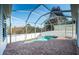 Screened-in pool with brick patio and white fence at 2930 Swan Cir, Dunedin, FL 34698